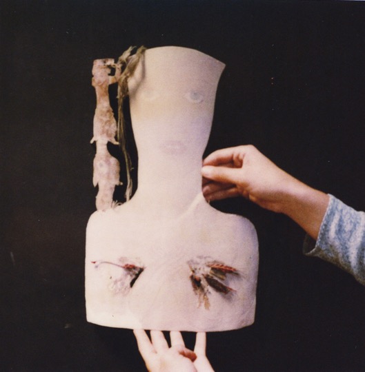 hands hold bust of cardboard figure